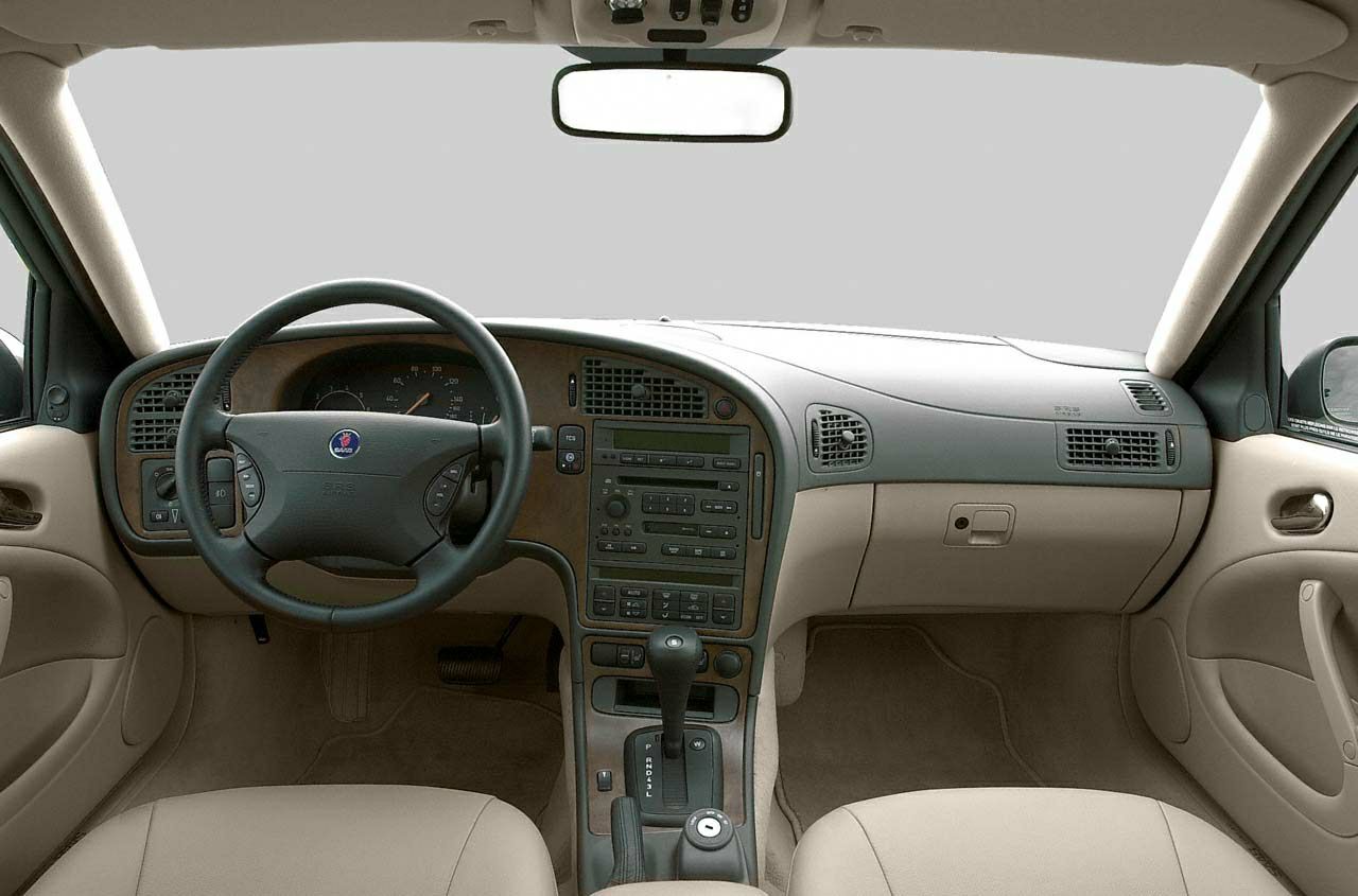 Dashboard and steering wheel with wood trim and central control panel