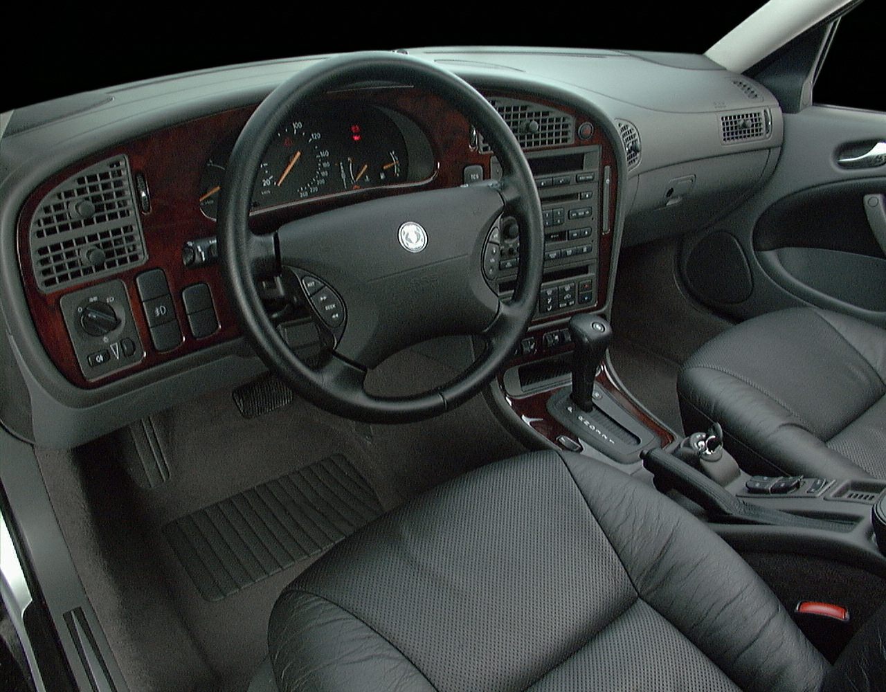 Dashboard with wood trim and steering wheel with integrated controls