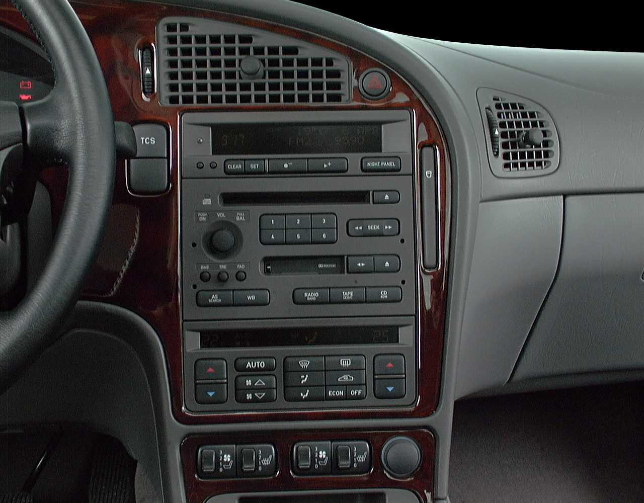 Classic dashboard wood trim, integrated audio, climate controls.