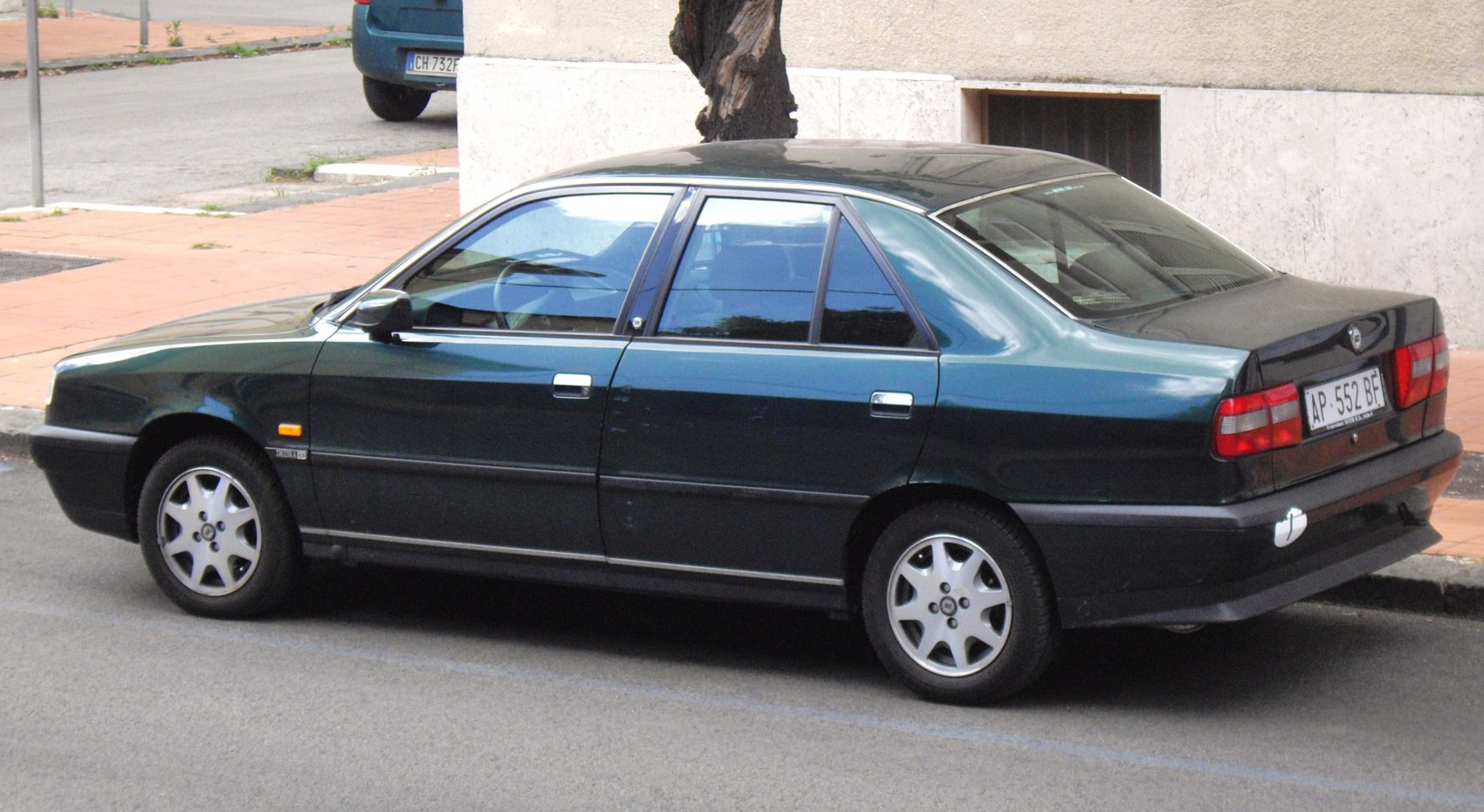 Side and rear view of a sedan with classic wheel rims.