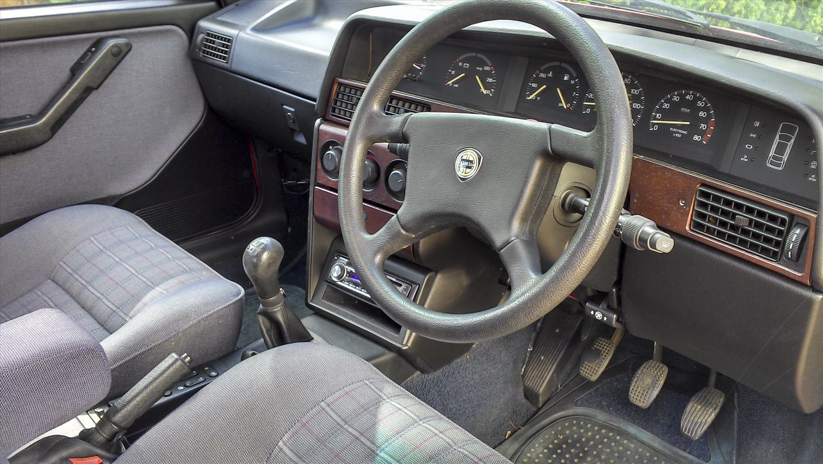 Right-hand drive interior with manual gearbox and vintage dashboard.