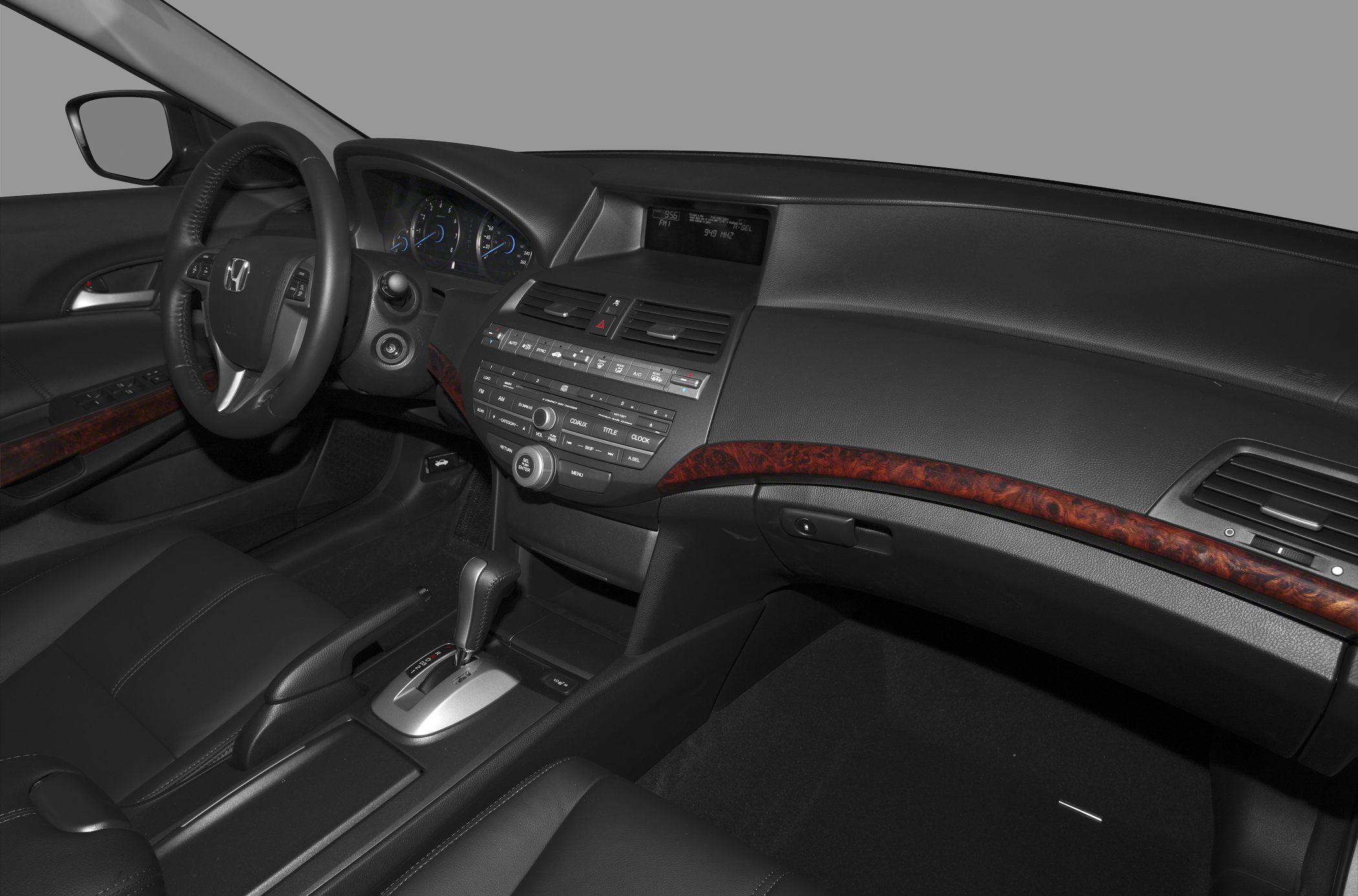 Interior dashboard with steering wheel and wood trim