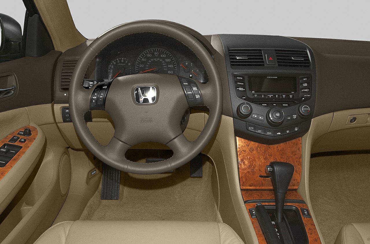 Steering wheel with control buttons and wood-trimmed center console