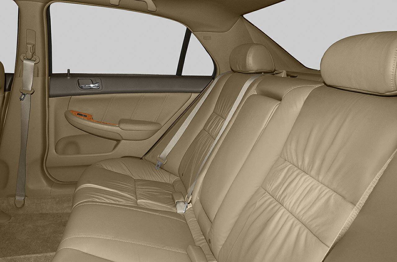 Beige leather rear seats with headrests and seatbelts