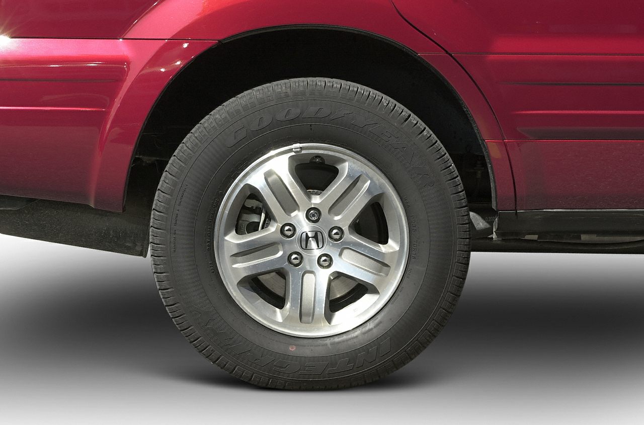 Close-up of alloy wheel and Goodyear tire on SUV.