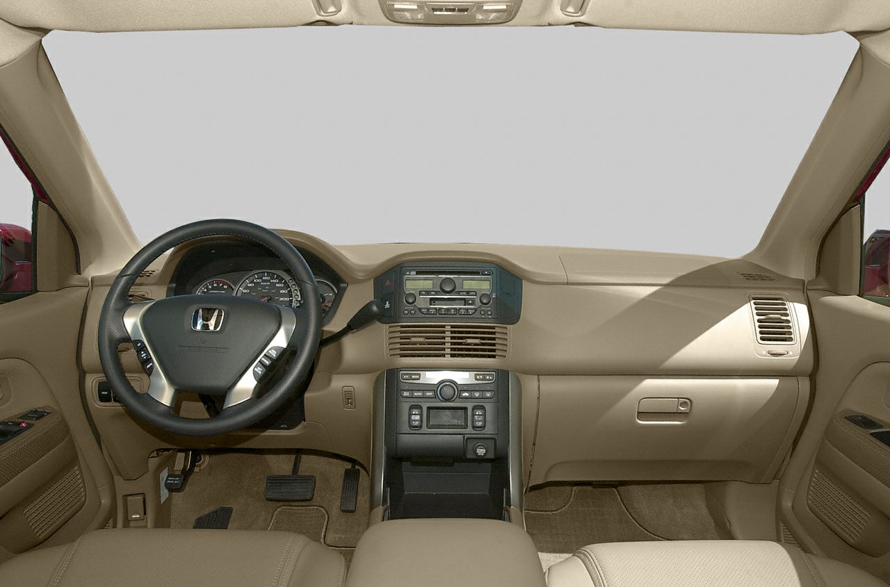 Beige dashboard, steering wheel, center console interior view