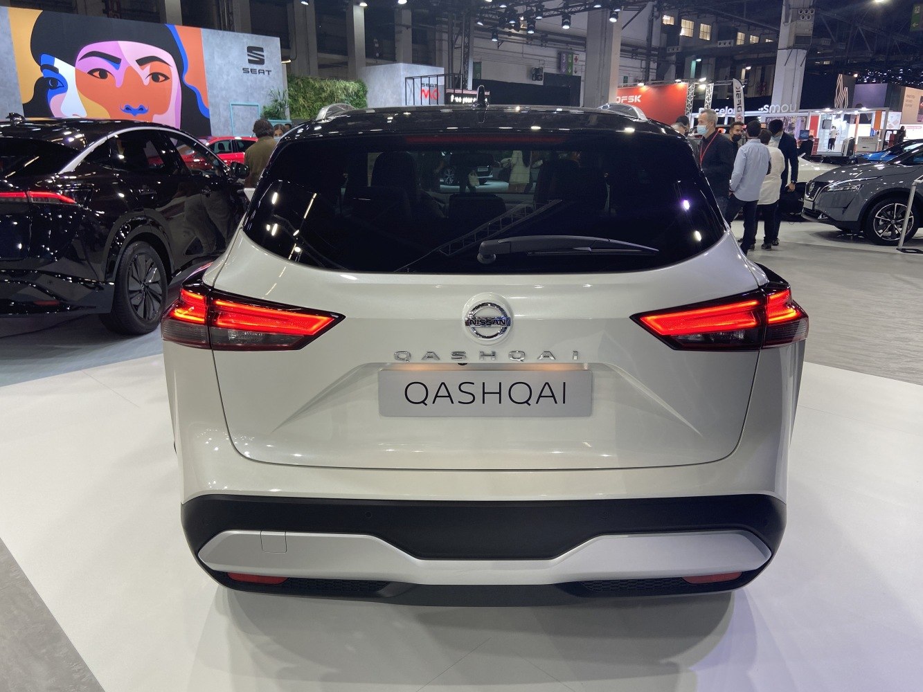 Rear view of a white SUV with sharp LED tail lights and rear windscreen wiper.