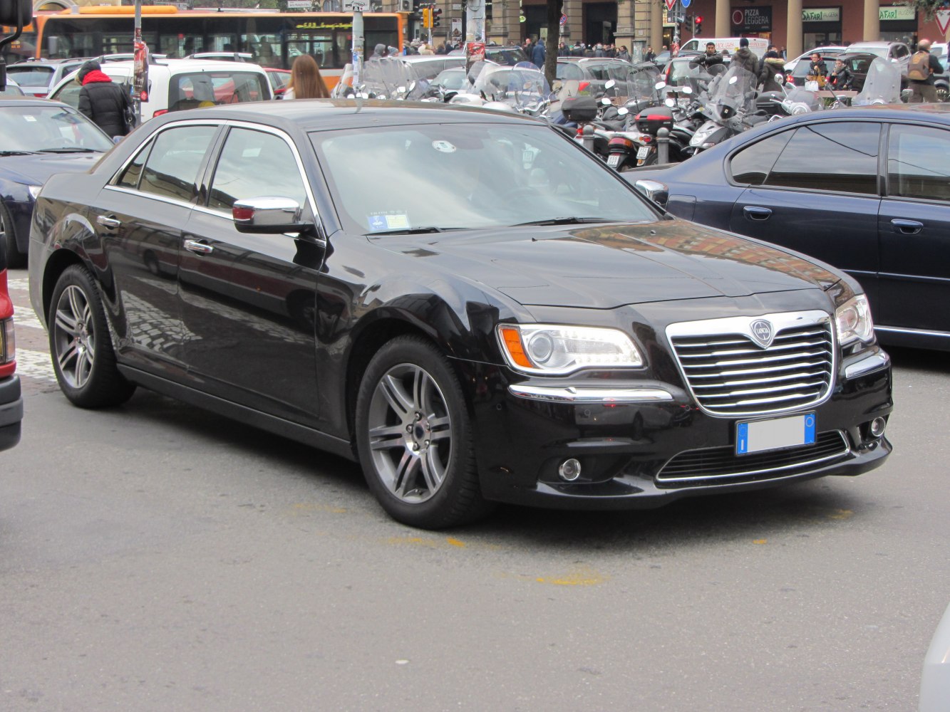 Black luxury sedan with prominent chrome grille and LED headlights