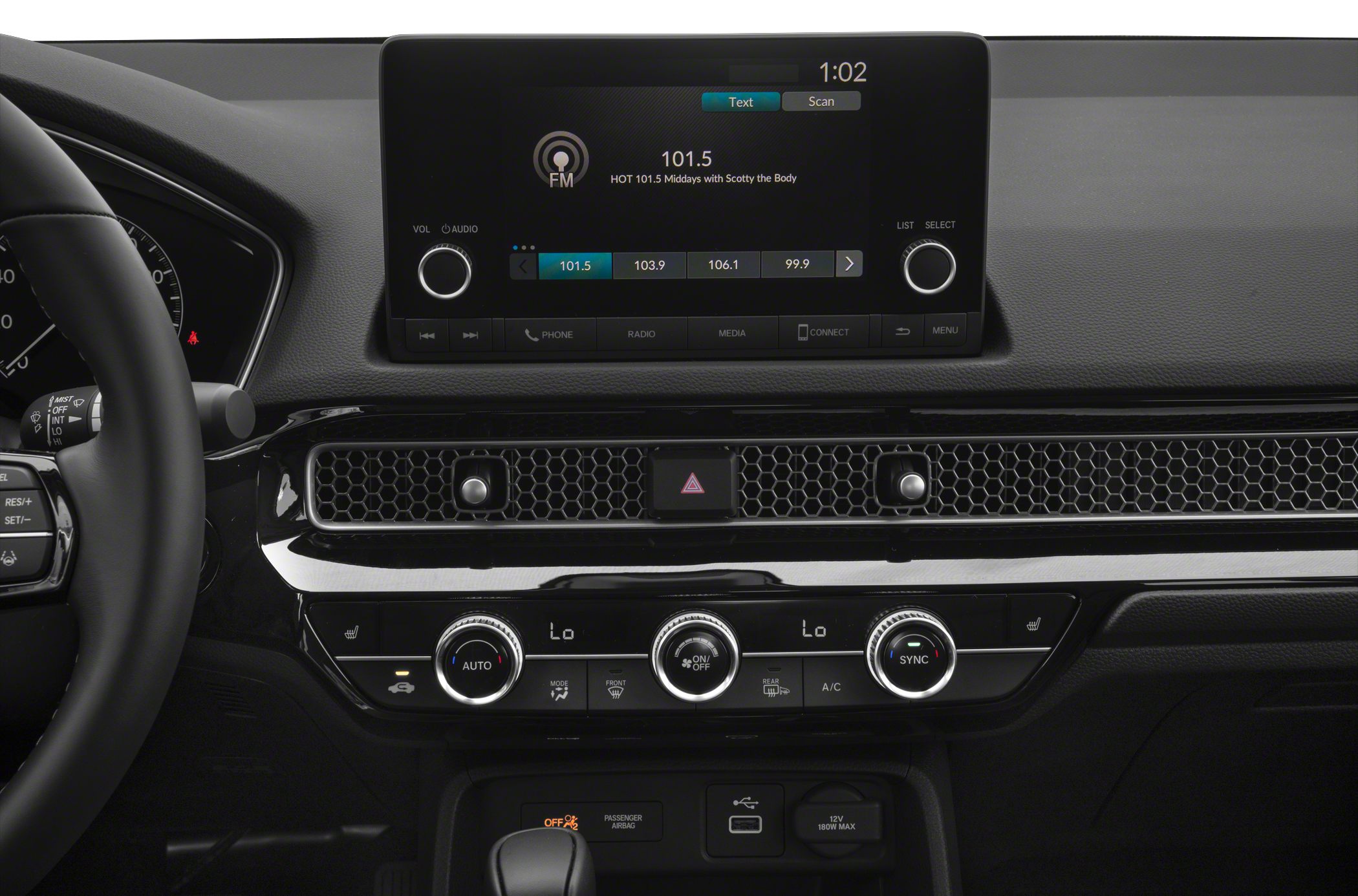 Car dashboard with infotainment screen and climate control knobs
