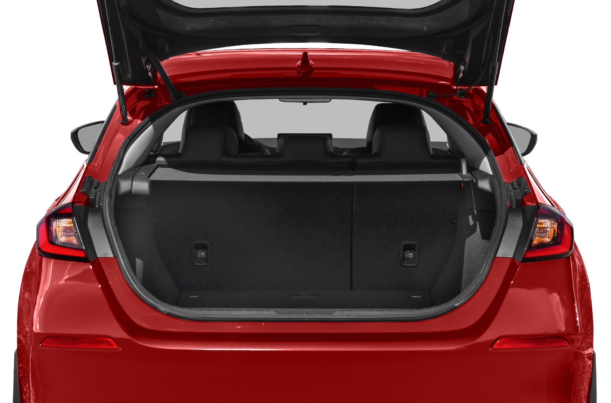 Spacious open rear hatch trunk with rear seats visible in red hatchback