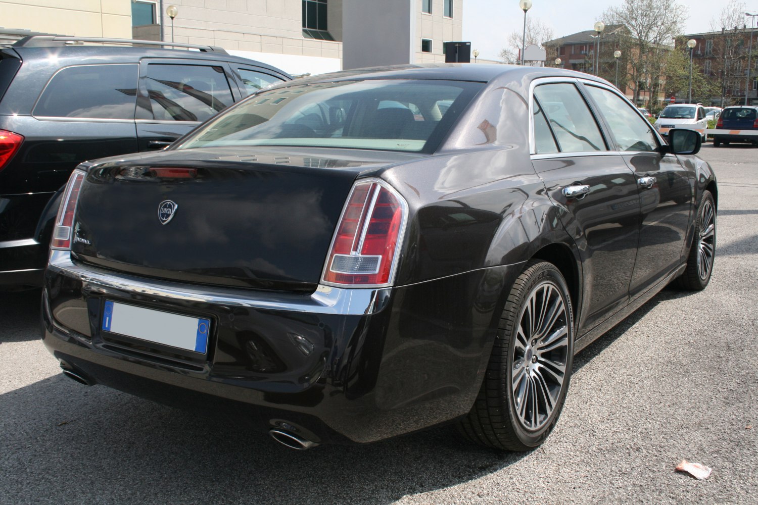 Rear view with taillights, alloy wheels, and dual exhausts