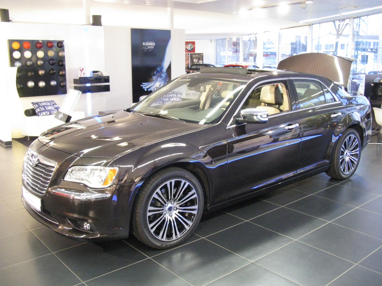 Chrome grille, multi-spoke wheels, beige leather interior luxury sedan