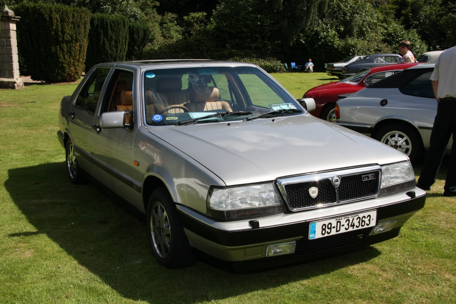 Front view of silver sedan with classic rectangular headlights and prominent grille.