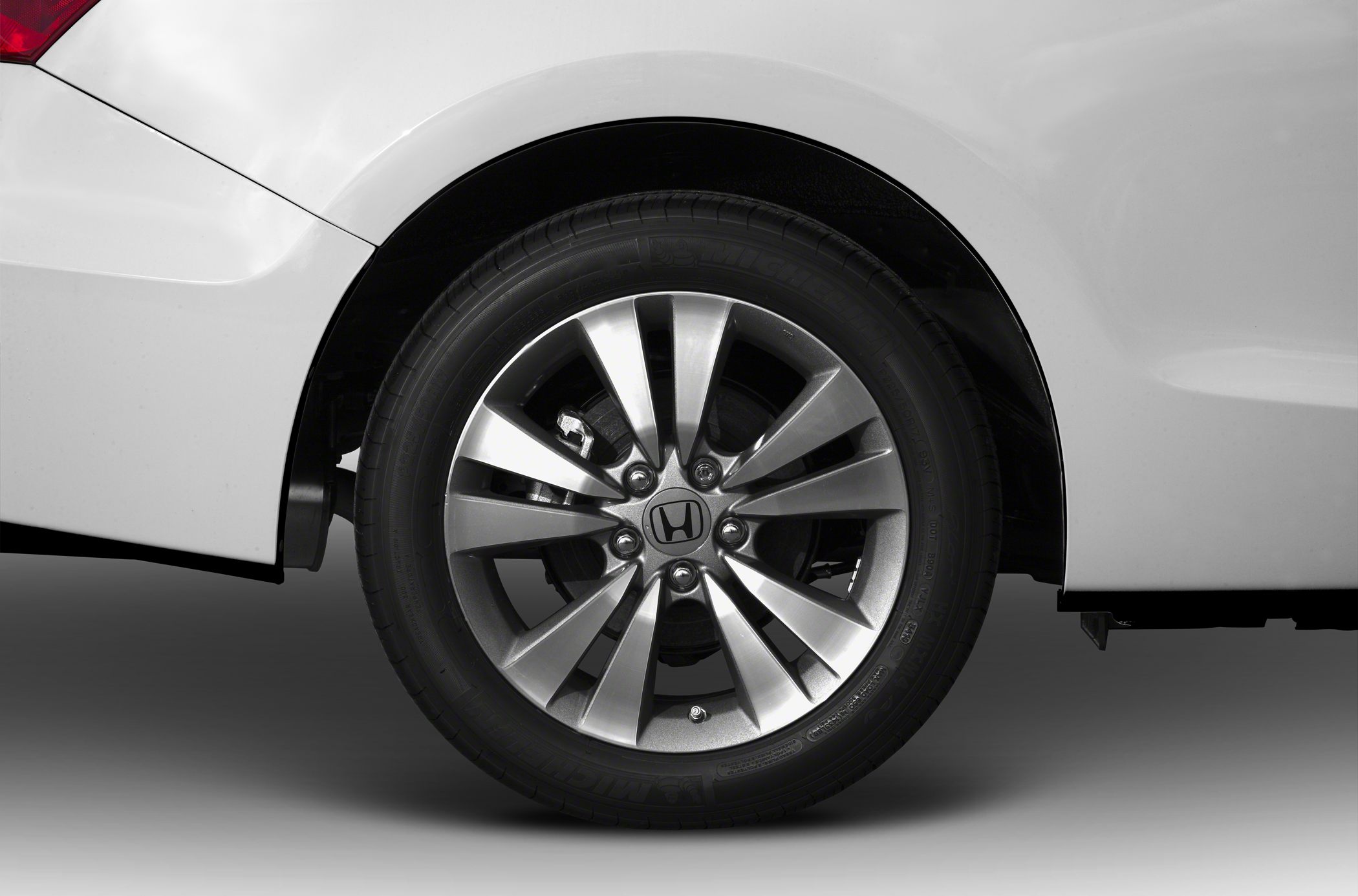 Close-up of a multi-spoke alloy wheel with Michelin tire on a car.