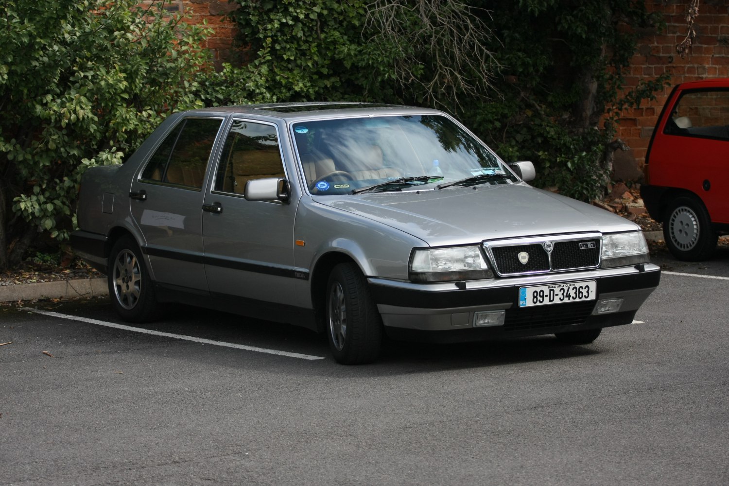 Angular sedan with rectangular headlights and black side moldings.