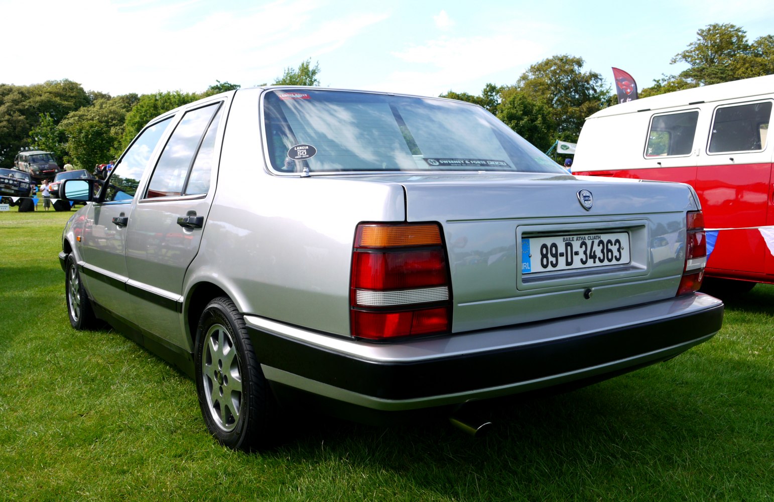 Rear and side view of silver classic luxury sedan with distinctive tail lights