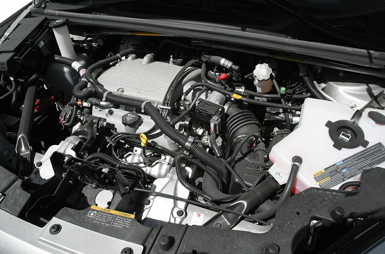 Engine bay with wiring harness and fluid reservoirs