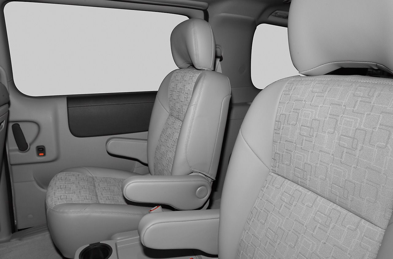 Front passenger seats with fabric and armrests in vehicle interior