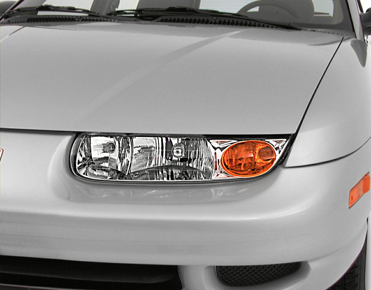 Close-up of front headlight and amber turn signal light