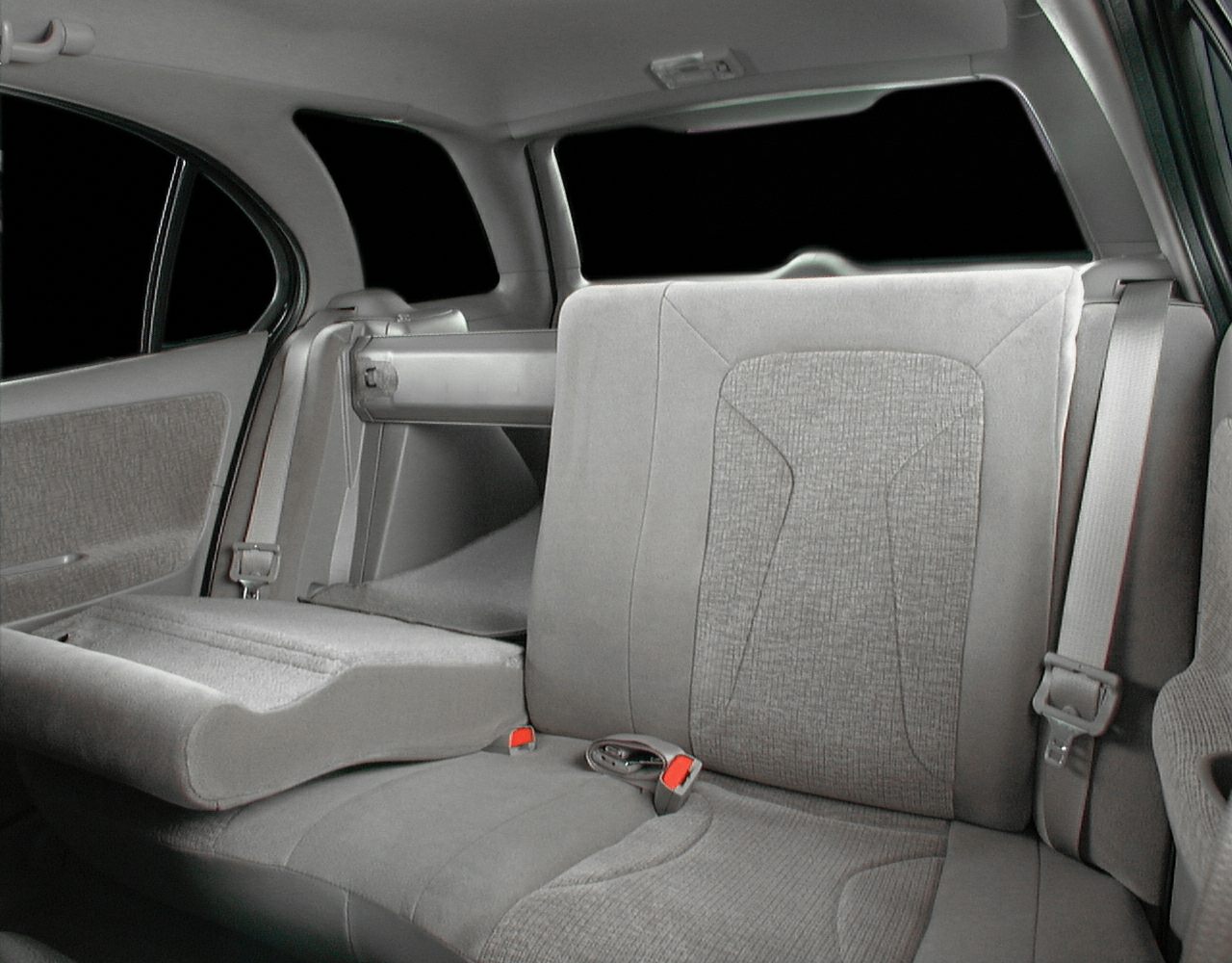 Fold-down center armrest in rear seat with seatbelt and upholstery details