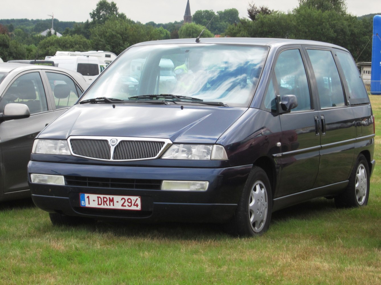 Minivan with dual sliding doors and distinctive front grille.