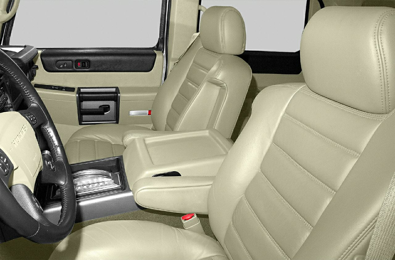 Beige leather front seats with center console and steering wheel