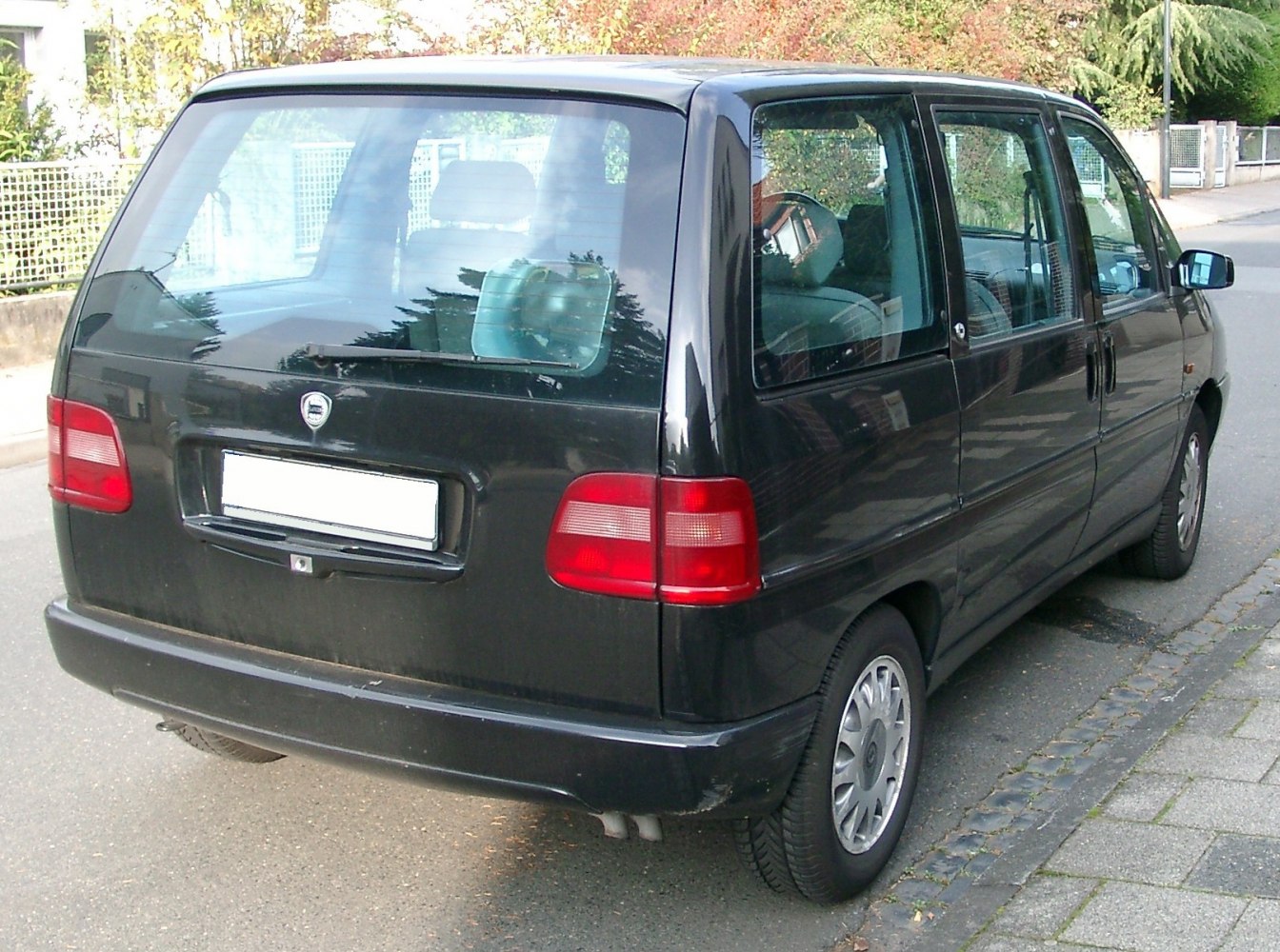 Rear of minivan with large window and prominent taillights