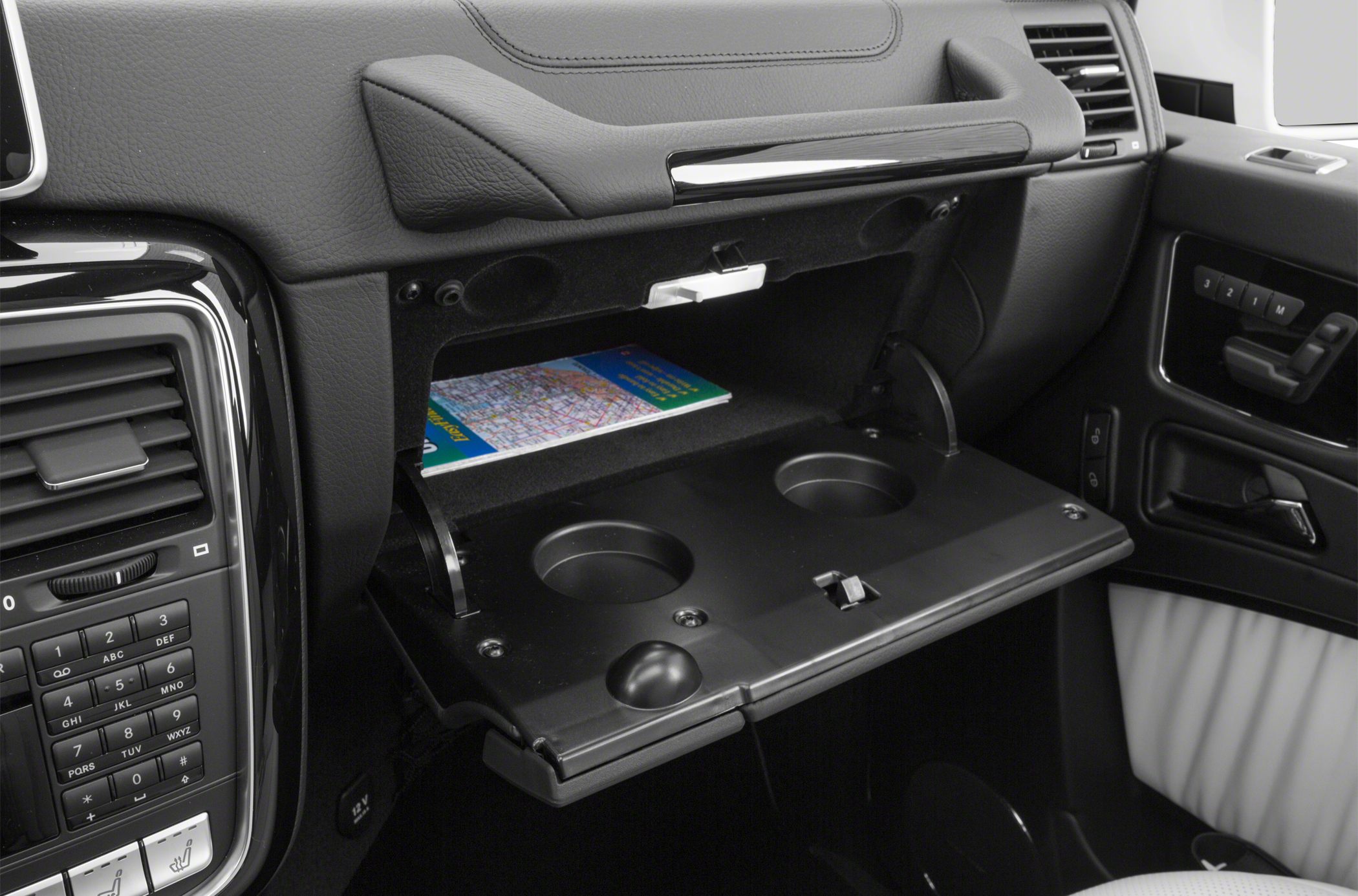 Open glove compartment with dual cup holders in car interior