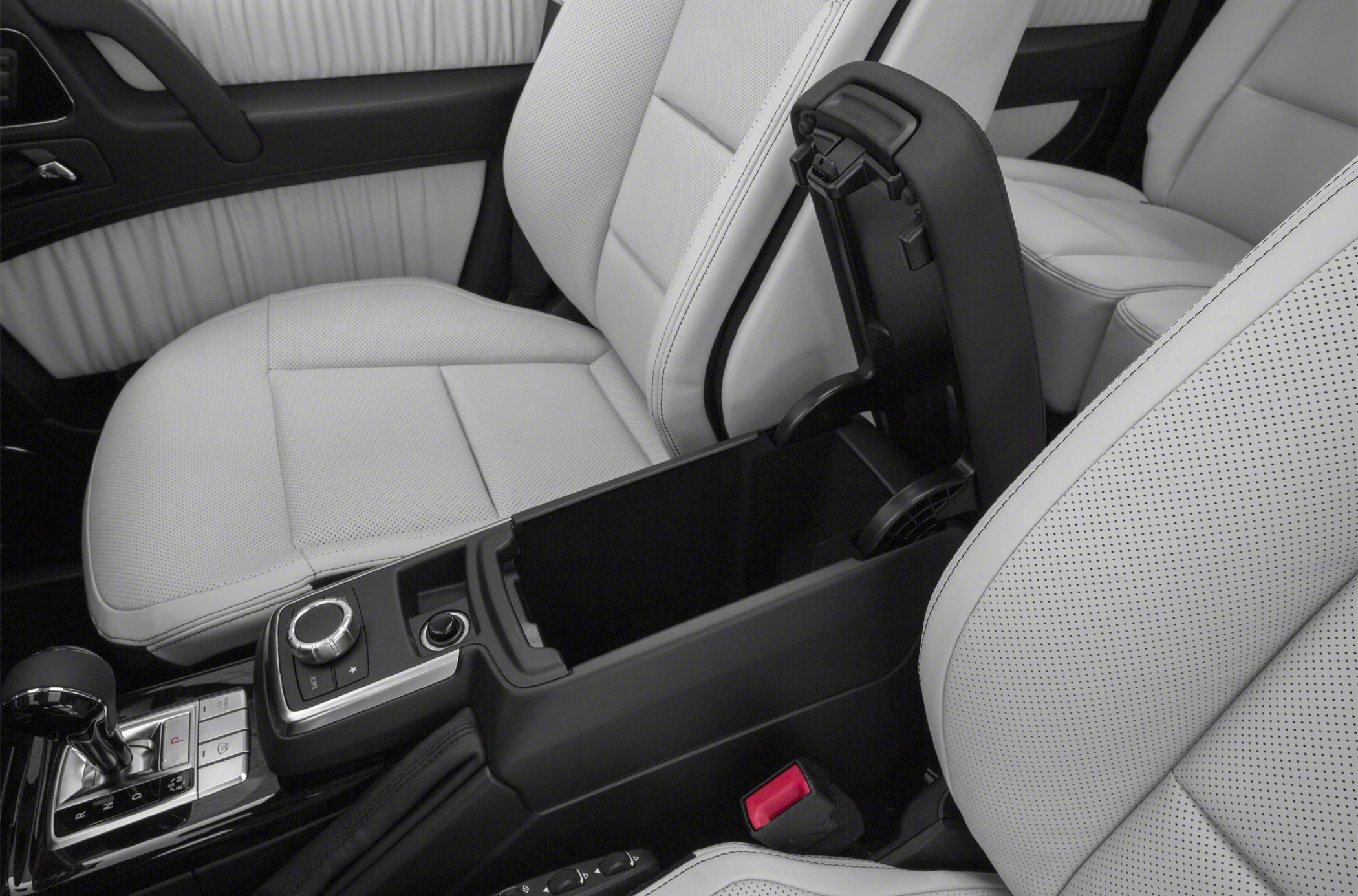 White perforated leather seats with open center console storage and gear shift details