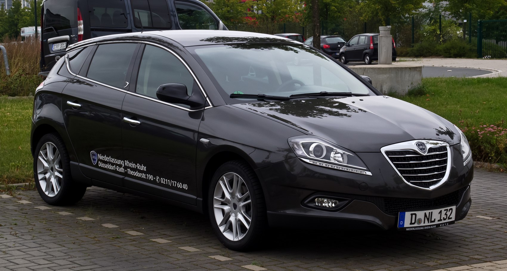Front-side view of black hatchback with modern headlights and alloy wheels