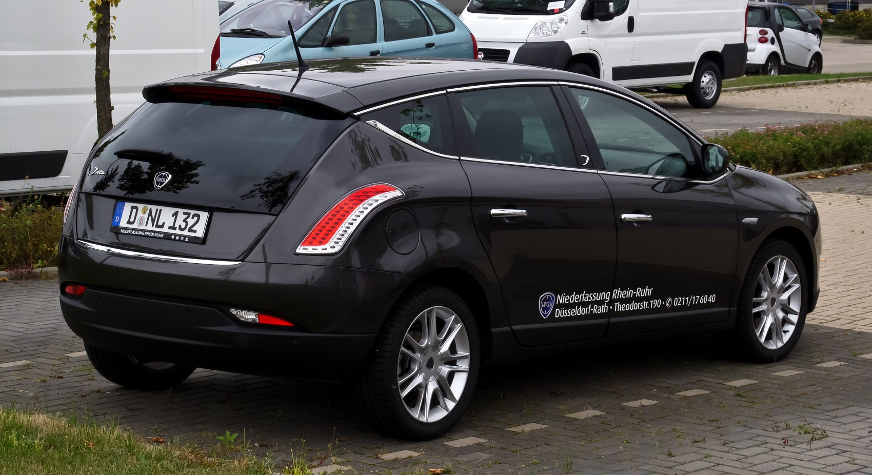 Rear-side view of black hatchback with distinctive taillights and alloy wheels