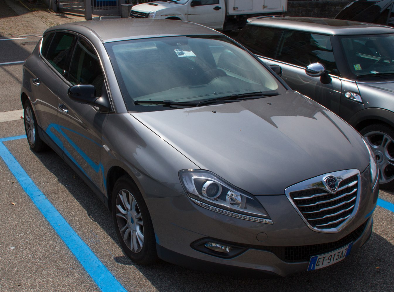 Front and side view of a silver five-door hatchback with distinctive grille and headlamps.