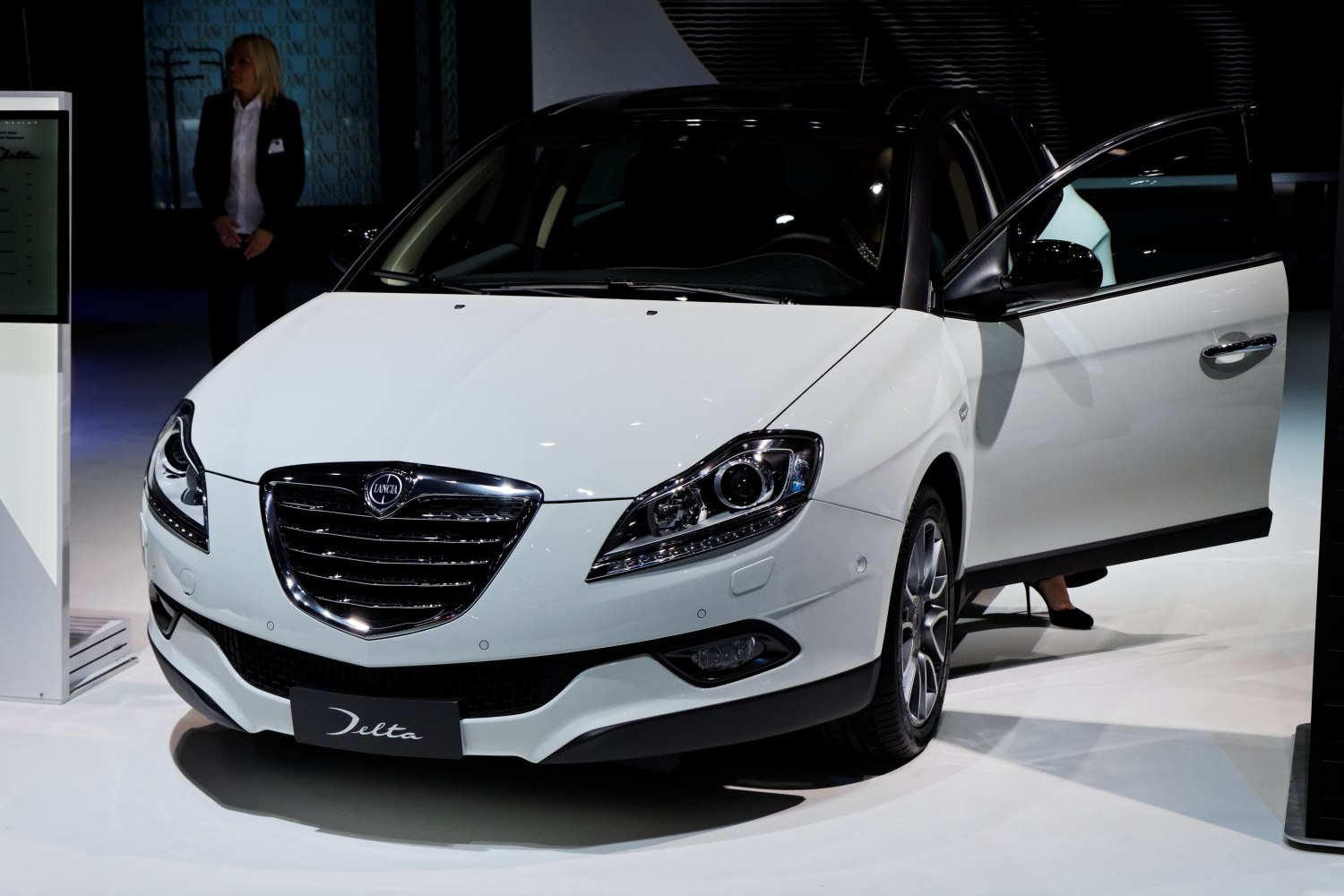 Front view with distinctive grille, modern headlights, and open front door