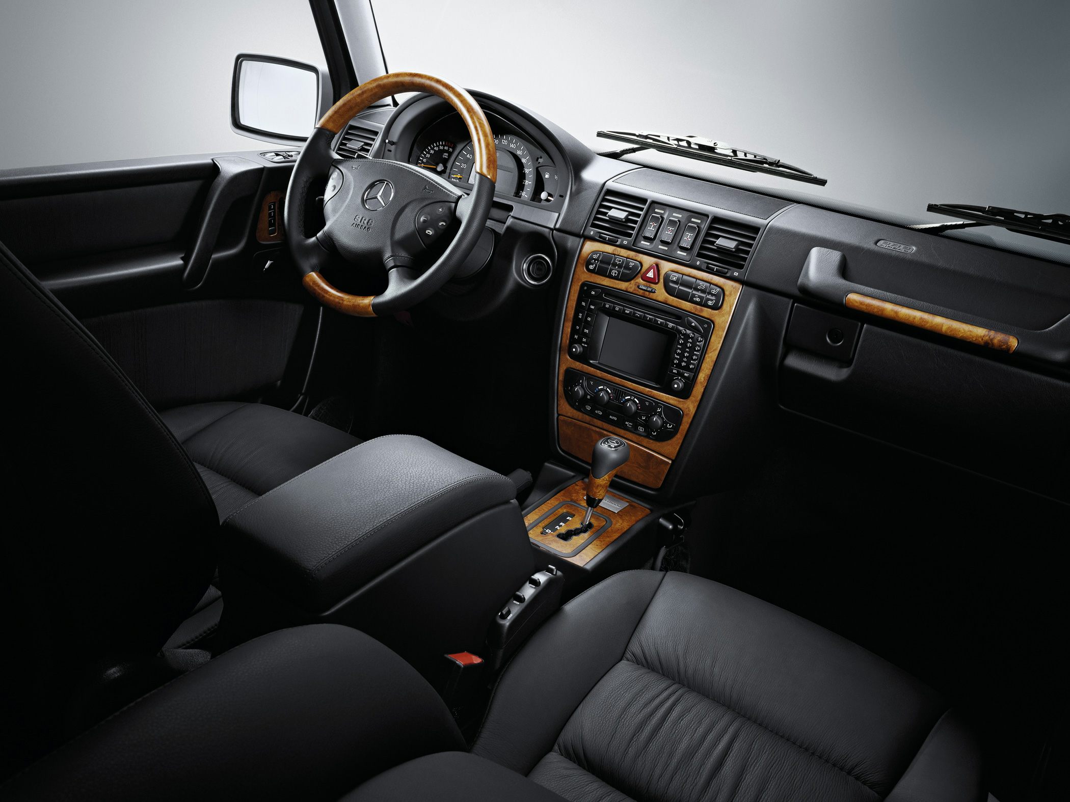 Black leather interior with wood trim dashboard and steering wheel
