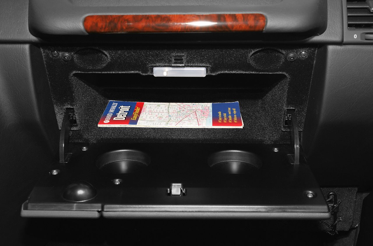 Open glove compartment with integrated cup holders and small storage space