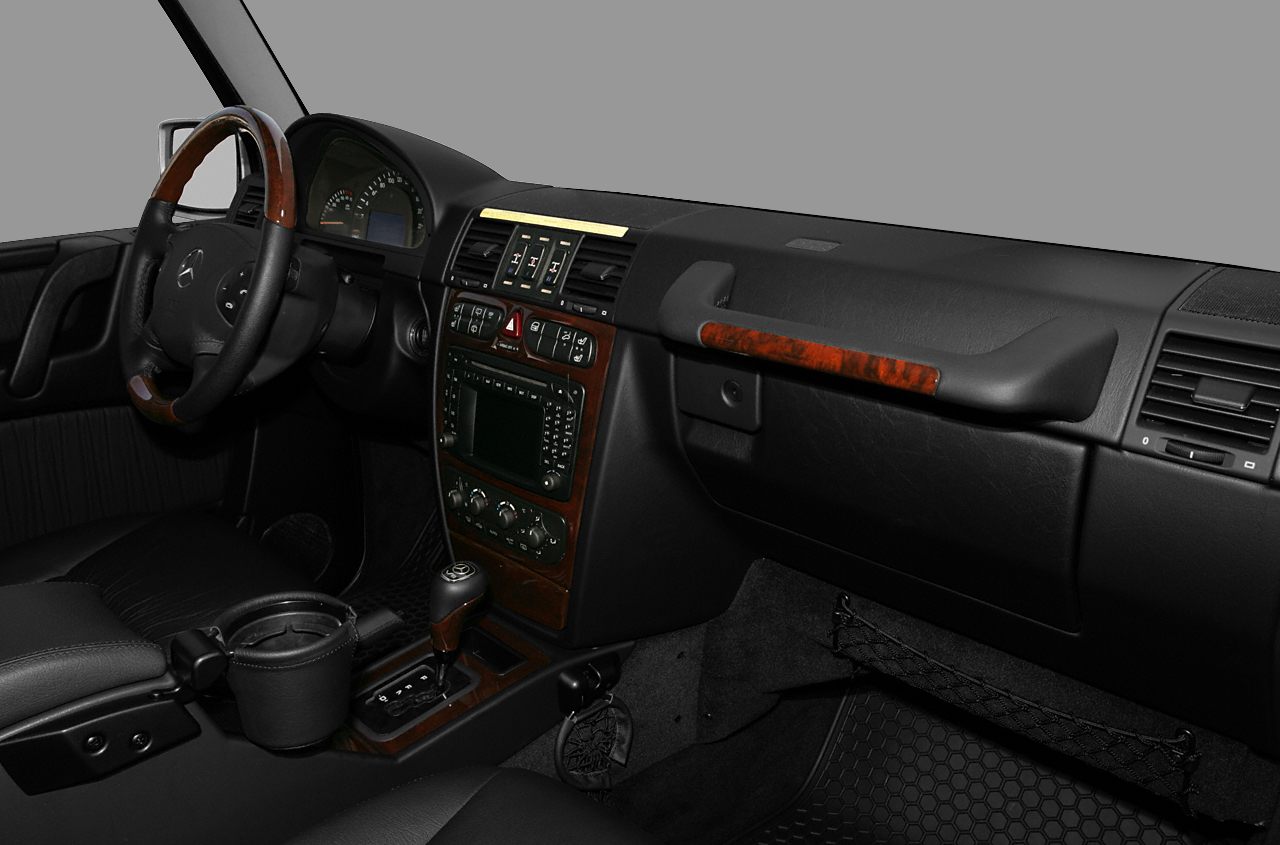 Dashboard and steering wheel with wood trim and ergonomic controls.