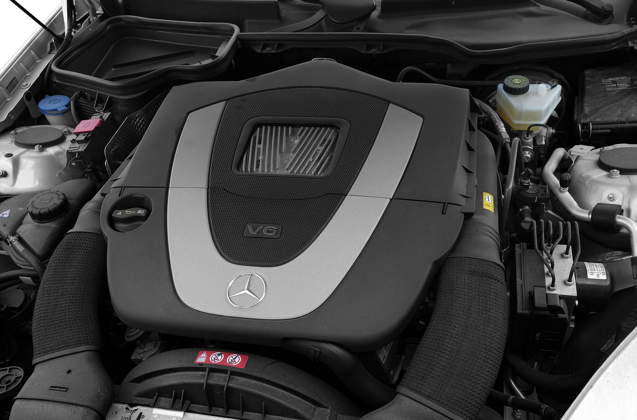 V6 engine cover with Mercedes-Benz emblem and components