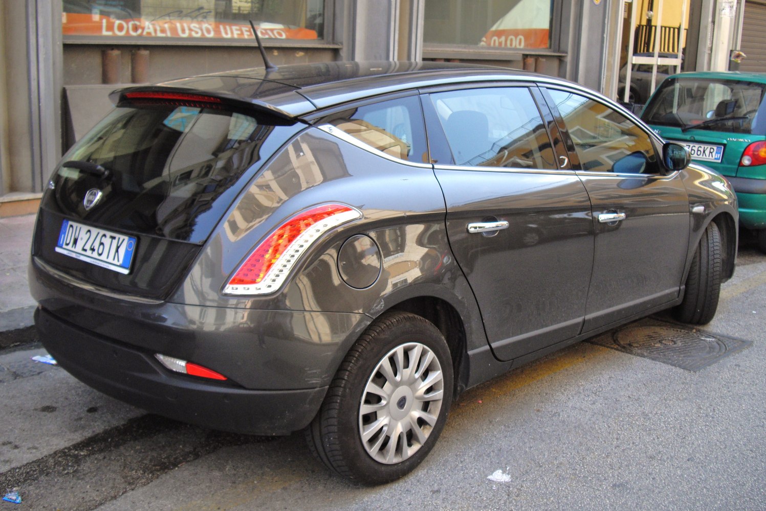 Rear side view with distinctive tail light design and hatchback features