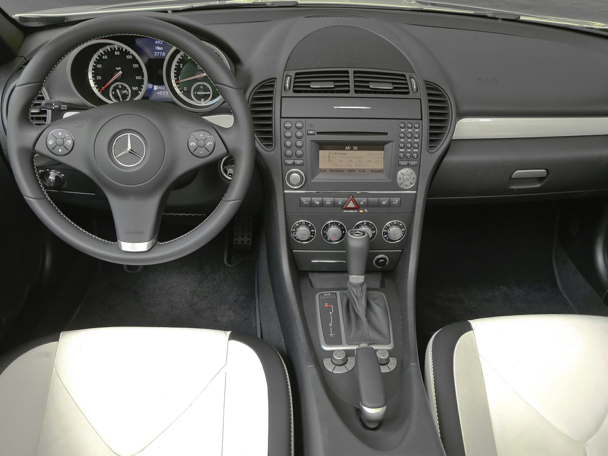 Dashboard, steering wheel, center console with controls in car interior
