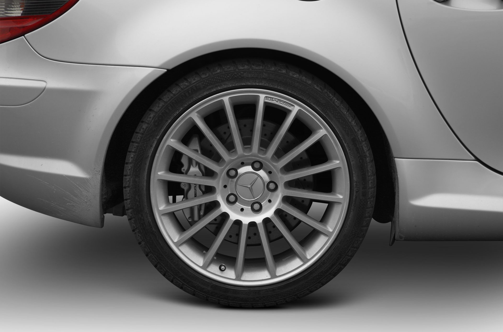 AMG multi-spoke alloy rear wheel with perforated brake disc and caliper.