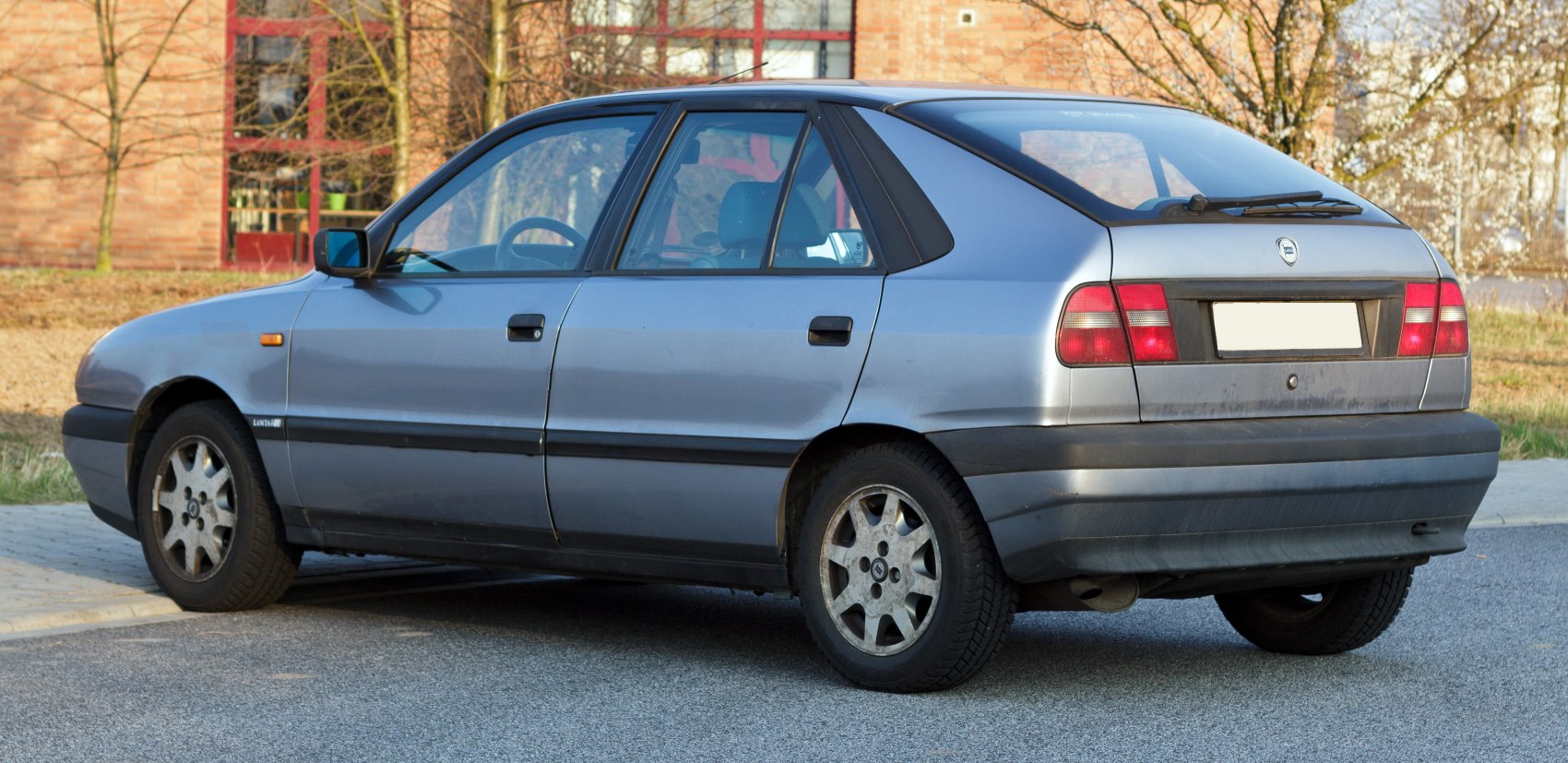 Silver five-door hatchback with alloy wheels and rear windshield wiper