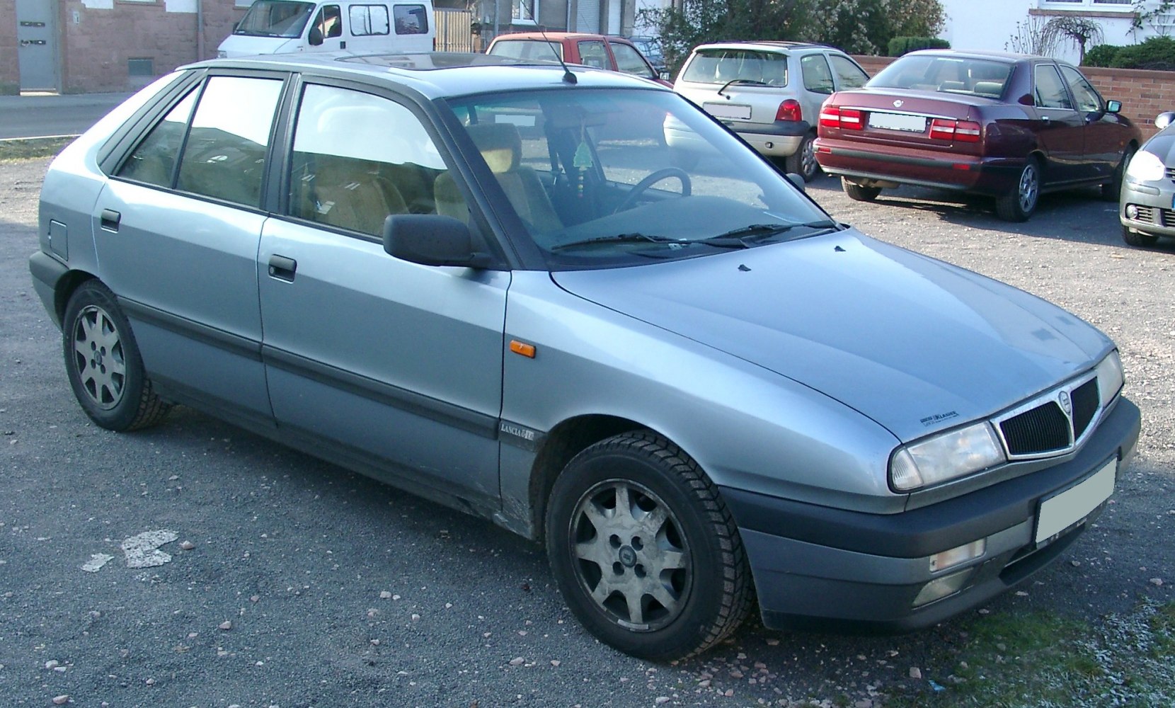 Front side view of a silver five-door hatchback with angular design