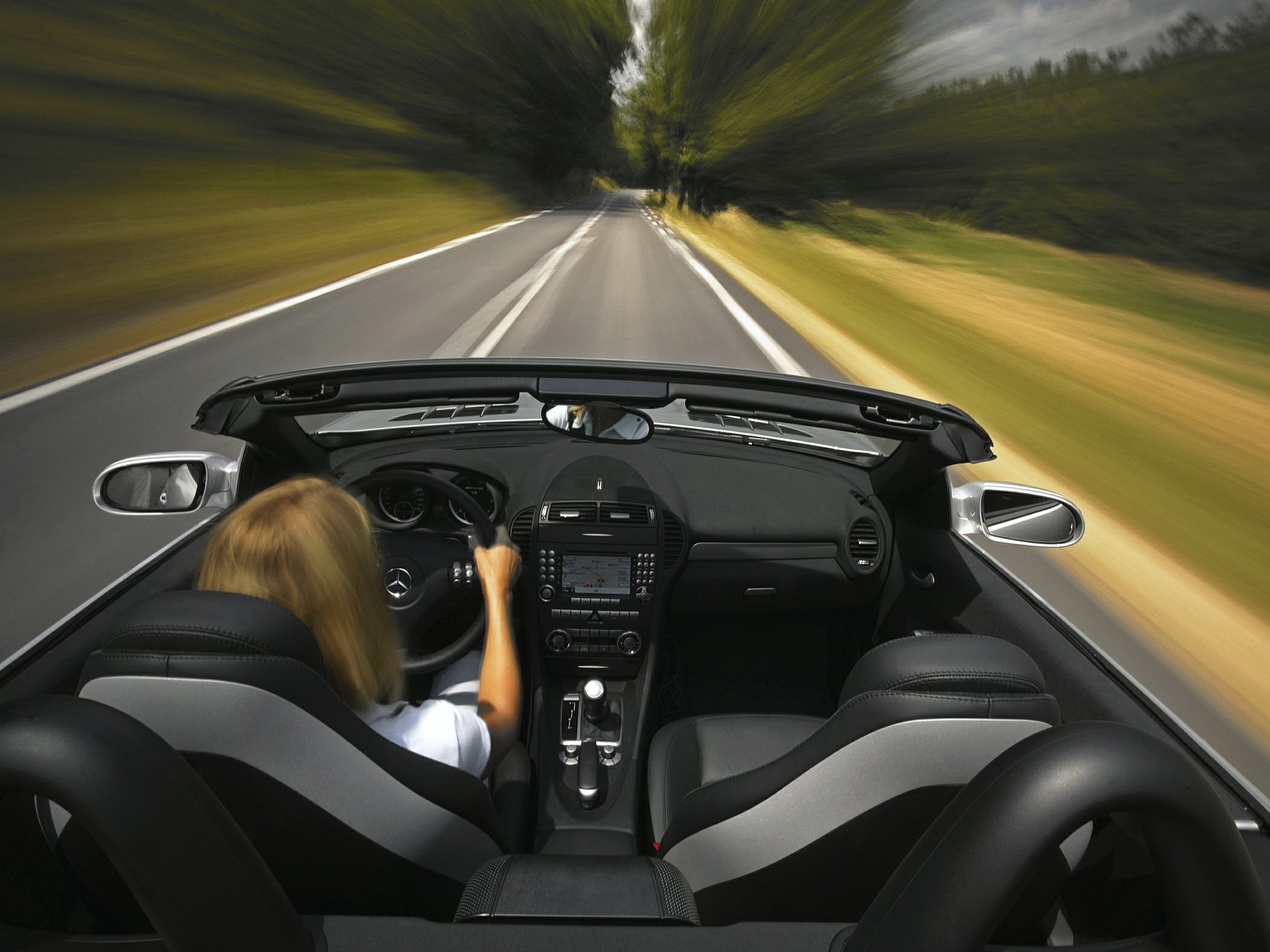 Convertible interior with sporty seats and navigation system on dynamic road