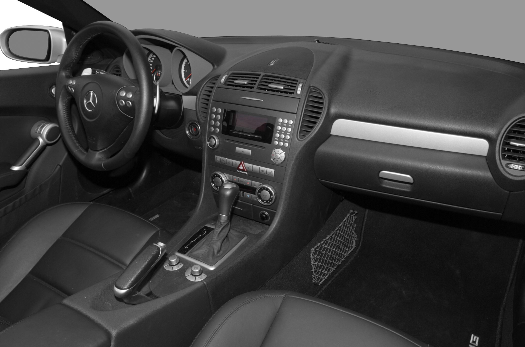 Black interior dashboard with steering wheel and center console featuring controls