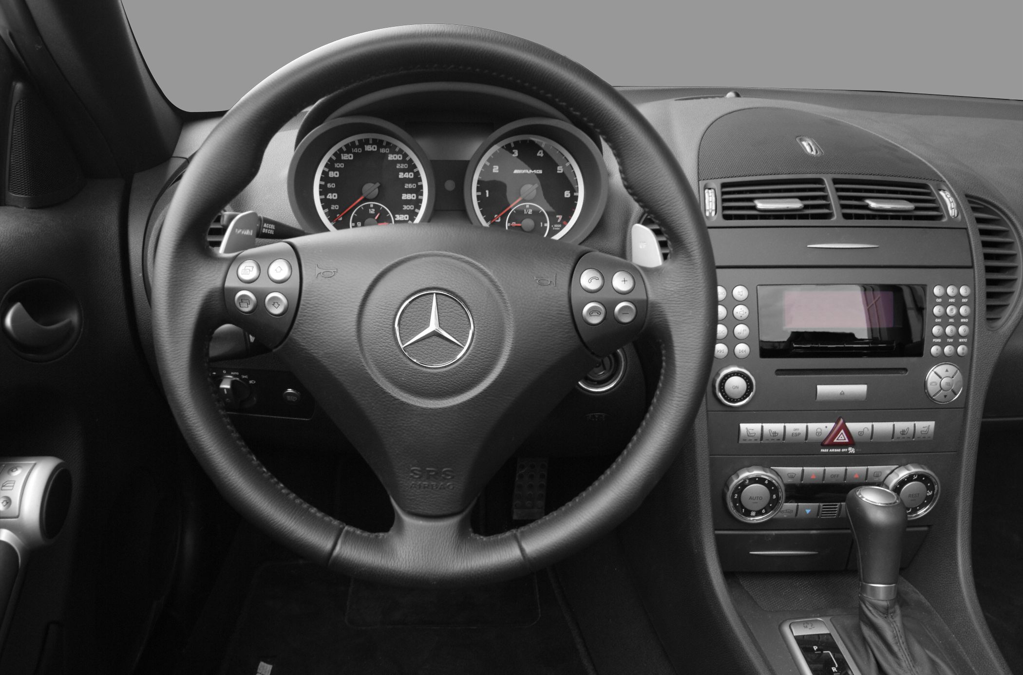 Steering wheel with AMG gauges, center console with climate and audio controls