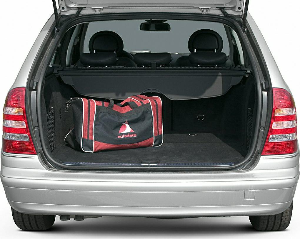 Open rear trunk with cargo cover and duffle bag in estate car.