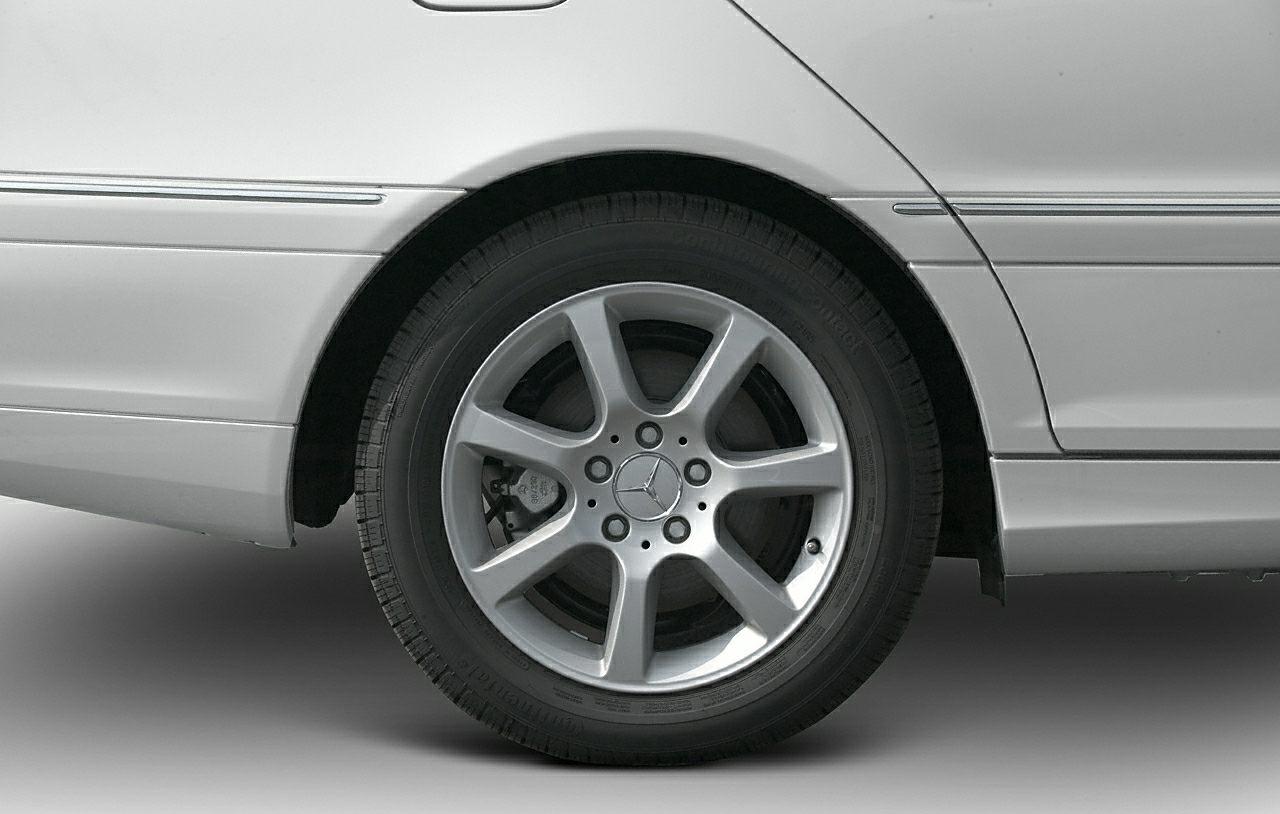 Close-up of silver alloy wheel and rear side panel section