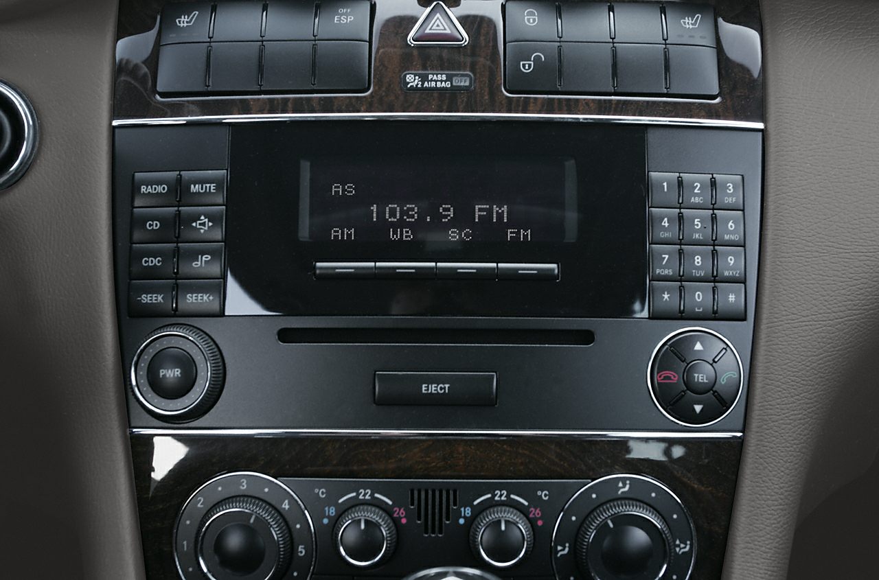 Close-up of car audio system and climate control knobs
