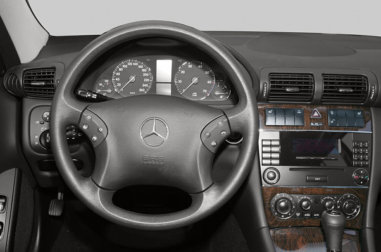 Steering wheel and dashboard with wood trim and control buttons