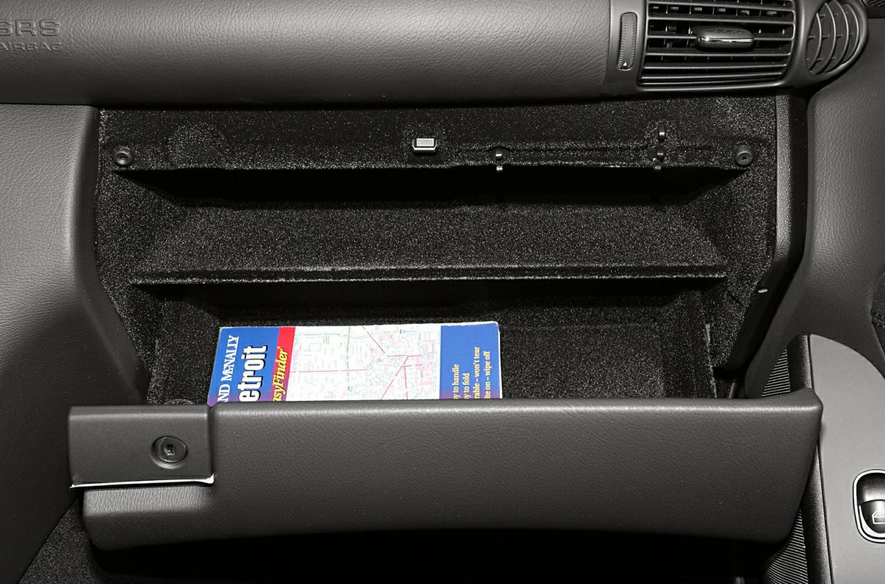 Open glovebox compartment with a map inside